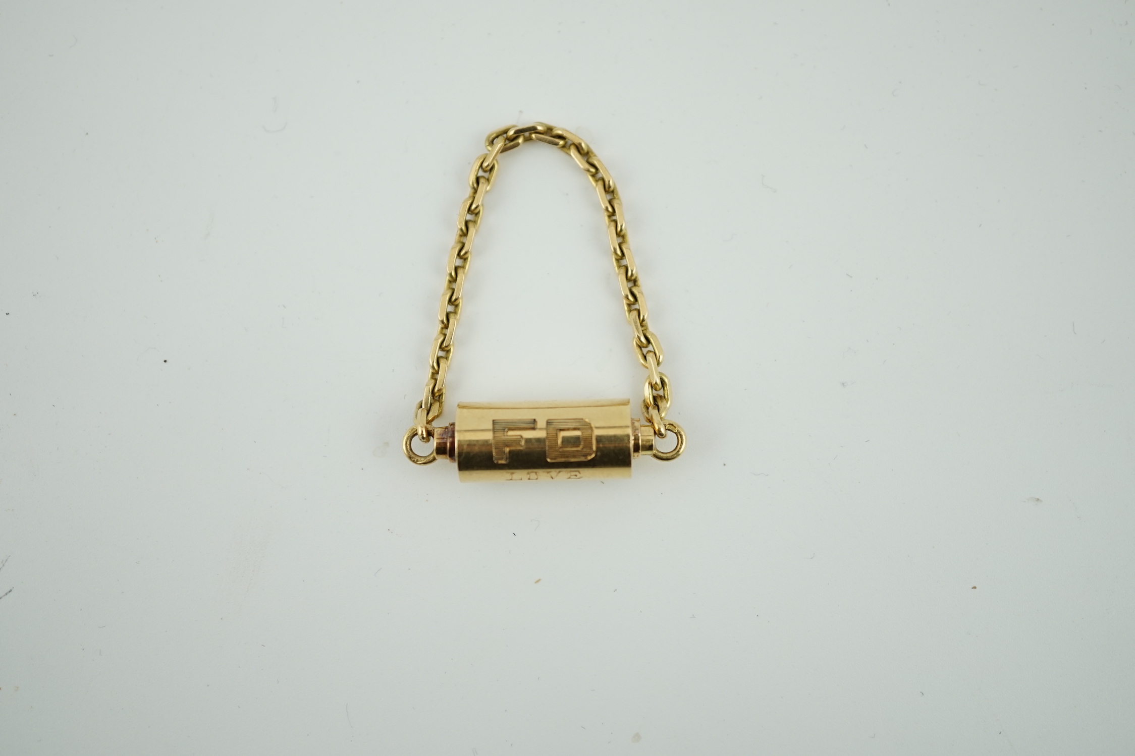 A mid to late 20th century Cartier 18ct gold barrel shaped key ring, with suspension chain